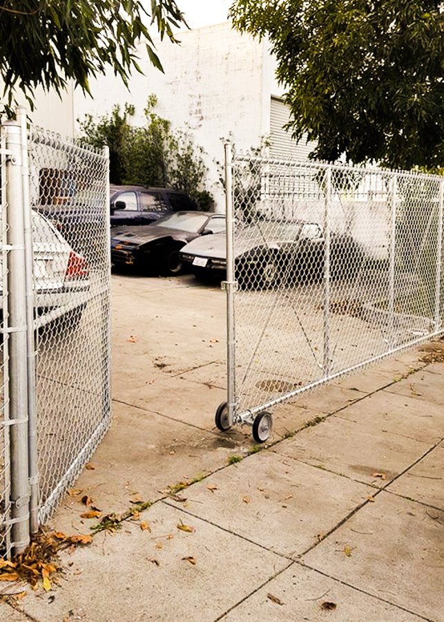 Outdoor chain link fence and rolling gated entry system